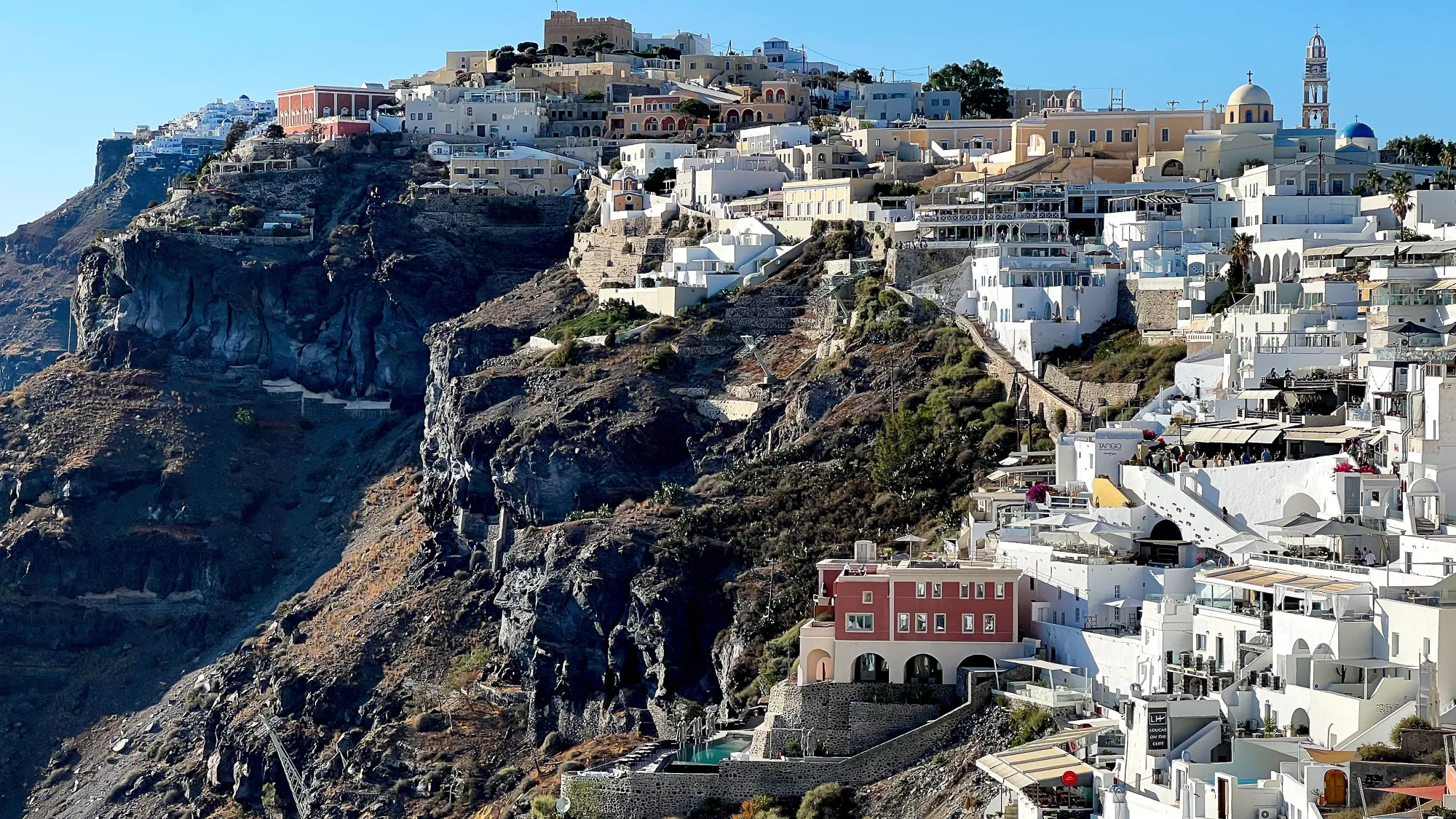Black earth with a terraced city of white buildings emerging from it