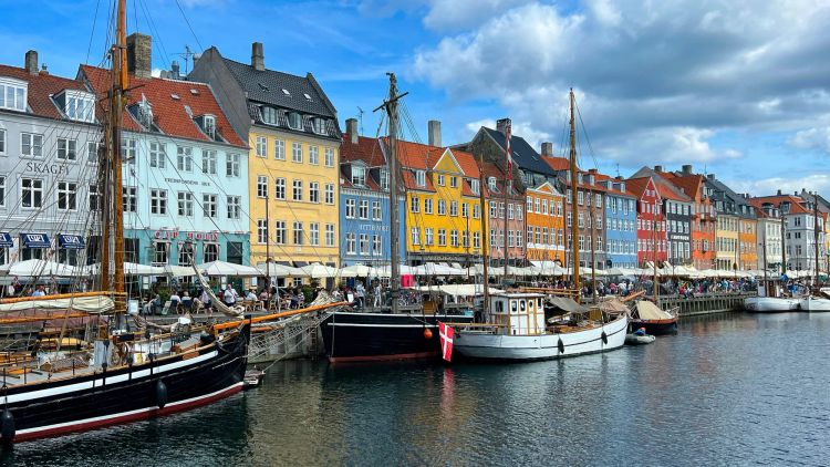 Waterway with colorful buildings lining it (blue, yellow, red)