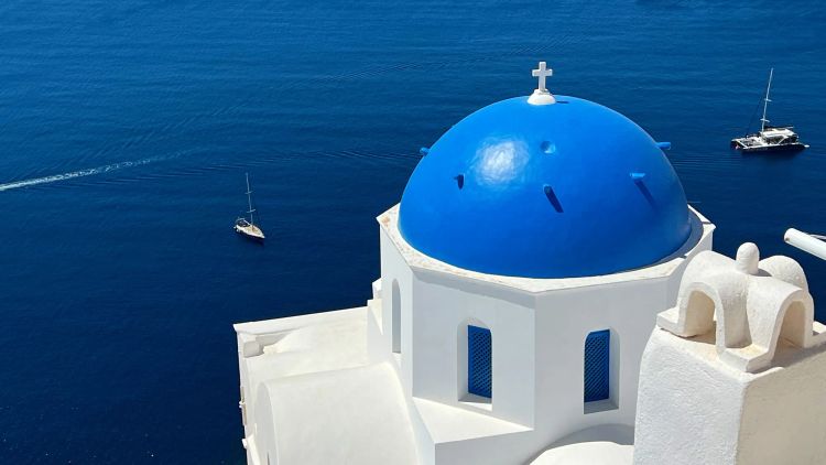 White washed building with a domed blue rooftop
