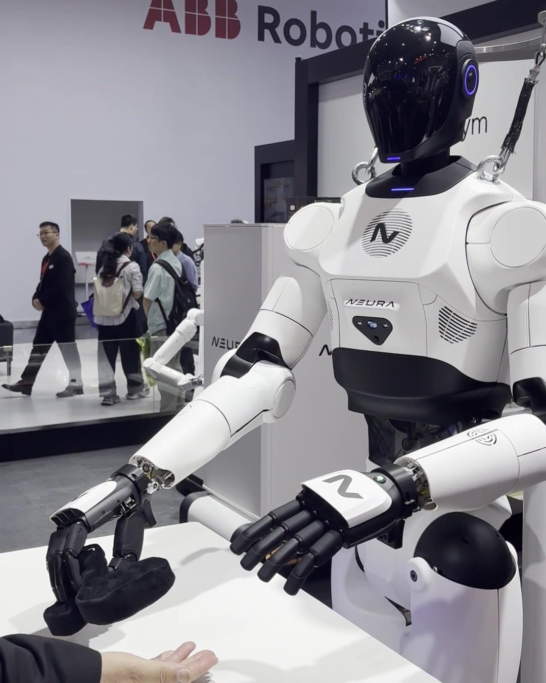 NEURA 4NE-1 humanoid robot standing still on a gantry with ABB Robotics sign behind, CIIF 2026
