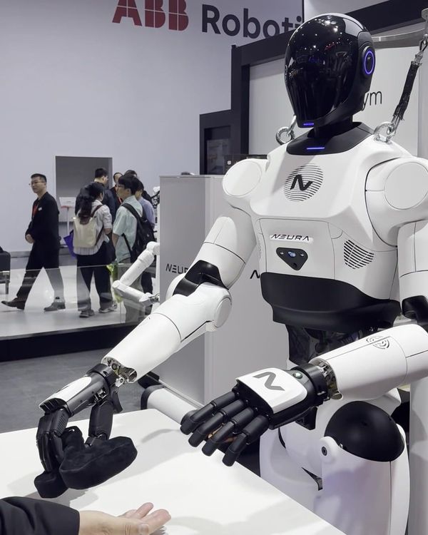 NEURA 4NE-1 humanoid motionless on its frame in front of the ABB booth at CIIF 2026, Shanghai