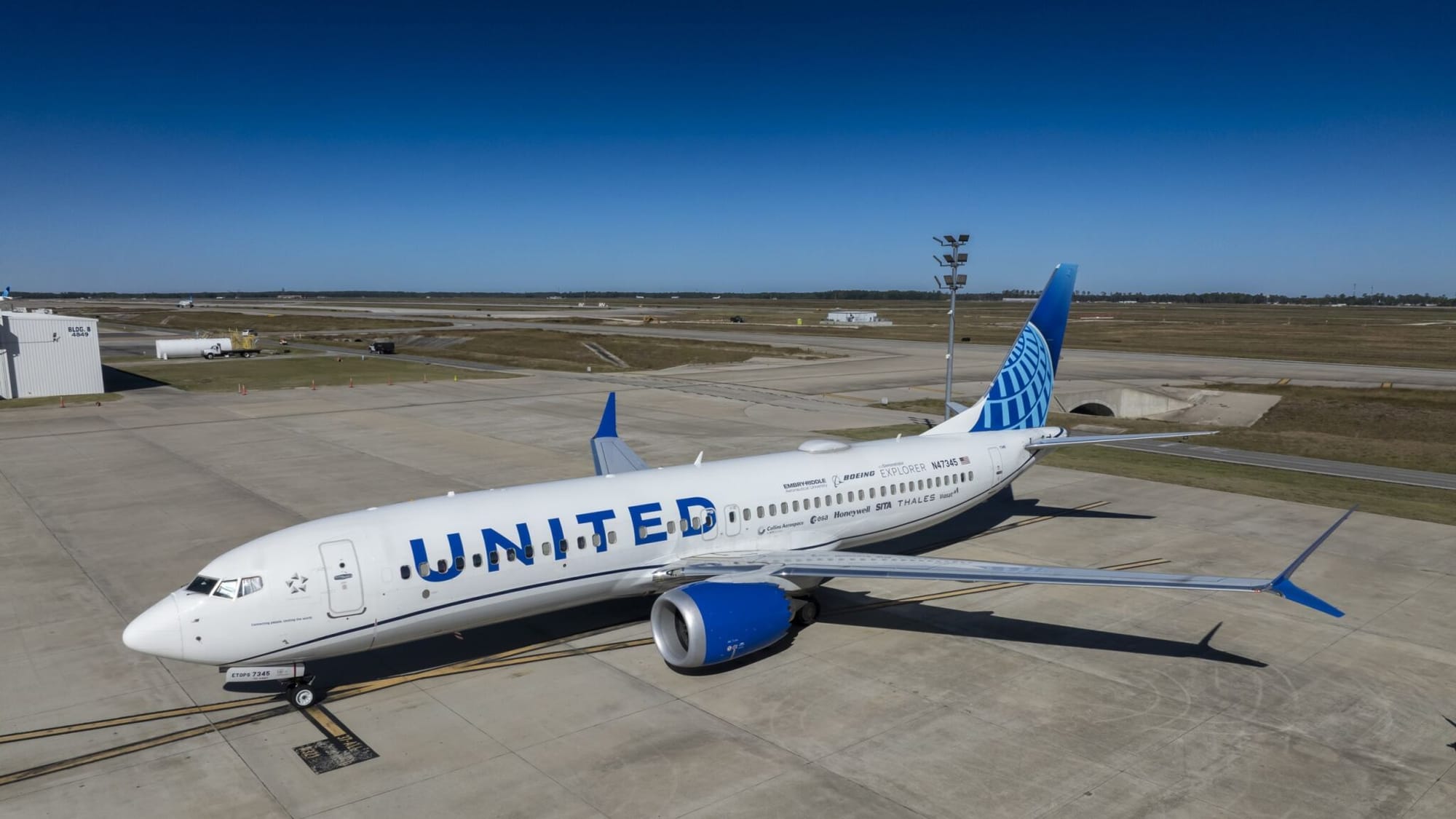 United Airlines Boeing 737-8 ecoDemonstrator aircraft parked on an airport apron during NASA and Boeing trajectory-sharing tests.