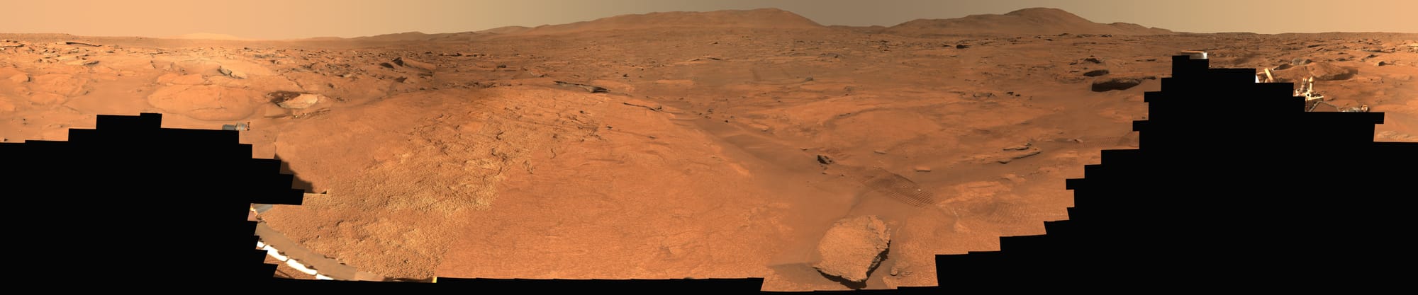 A wide Perseverance rover panorama of reddish terrain at Turquoise Bay on Mars.
