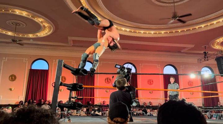 Travis Williams of Sinner and Saint suplexes Speedball Mike Bailey off the top rope at a Deadlock Pro Wrestling event at Logan Square Auditorium in Chicago. 