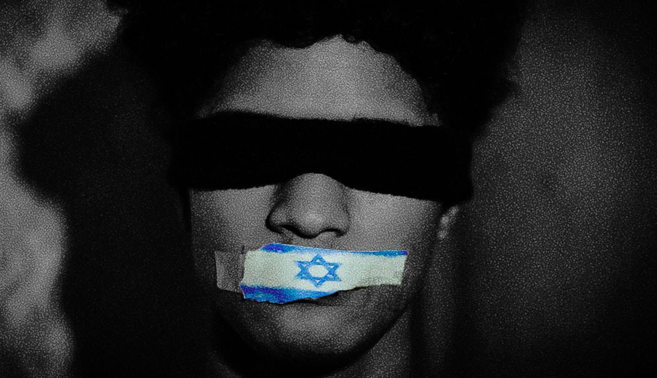 A person with their eyes covered by a black bandana and their mouth covered with the Israeli flag as tape