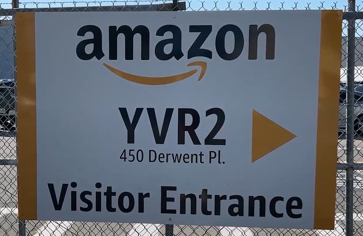 A sign for the visitor entrance to the YVR2 Amazon warehouse
