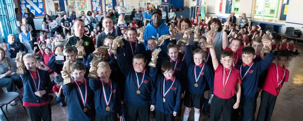 Former England international Emile Heskey presents prizes to double-winning Broadheath Primary