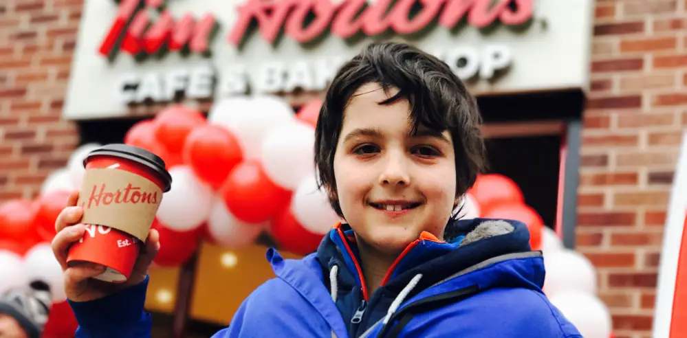 Oliver, 13, wins year’s supply of coffee as he’s first in the queue at opening of Tim Hortons’ new Altrincham restaurant