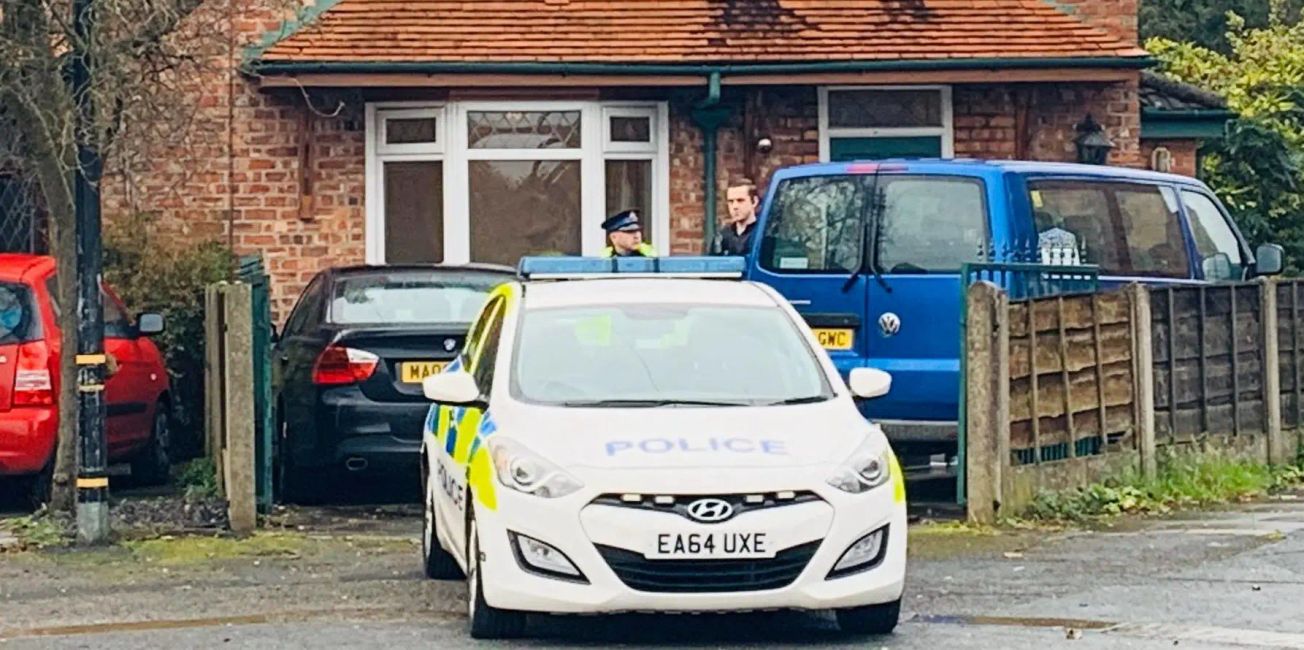 A man arrested after a woman was found dead at an Altrincham house has been released under investigation
