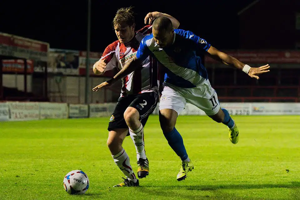 Captain Shaun Densmore fights to win a corner off the Eastleigh defender