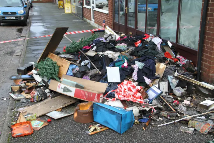 Fire-damaged possessions strewn outside the property this morning