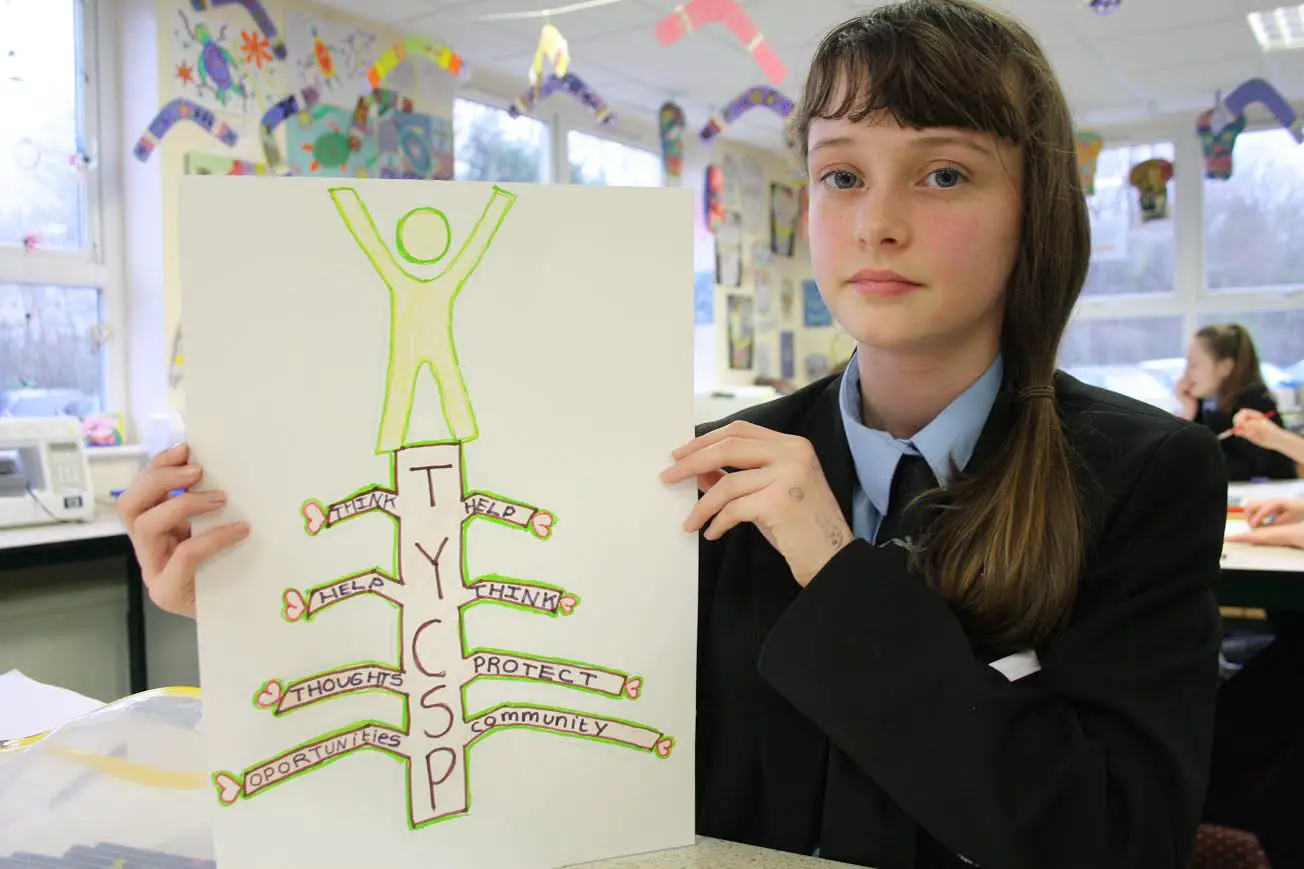 One of the students shows off her work