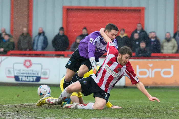 James Lawrie tangles with the Guiseley keeper