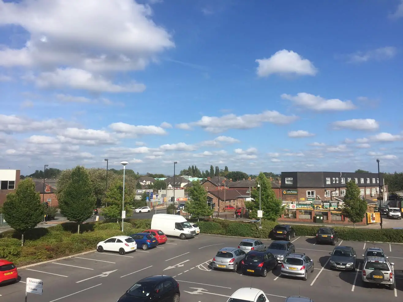 The view across to the two builders' merchants on Moss Lane