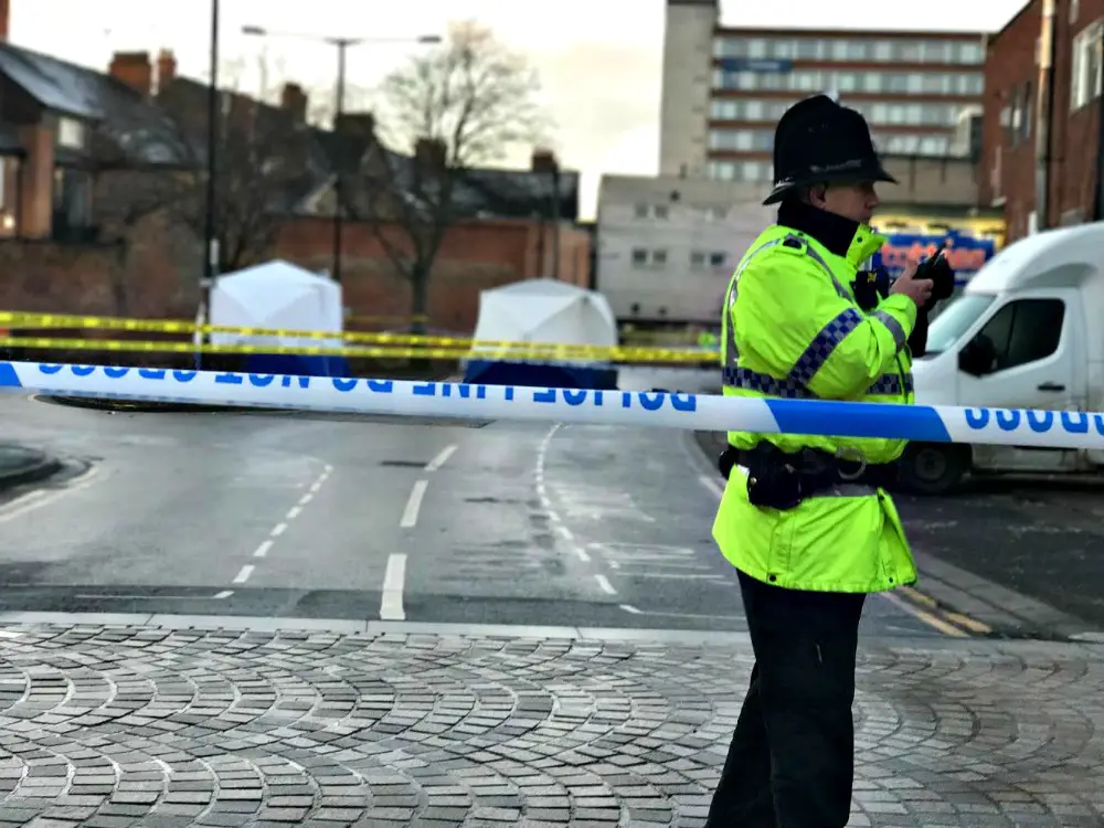 A policeman patrols the scene on The Causeway