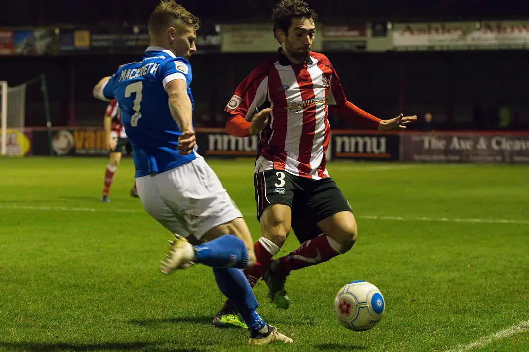 Andy McWilliams make a block against a Macclesfield player