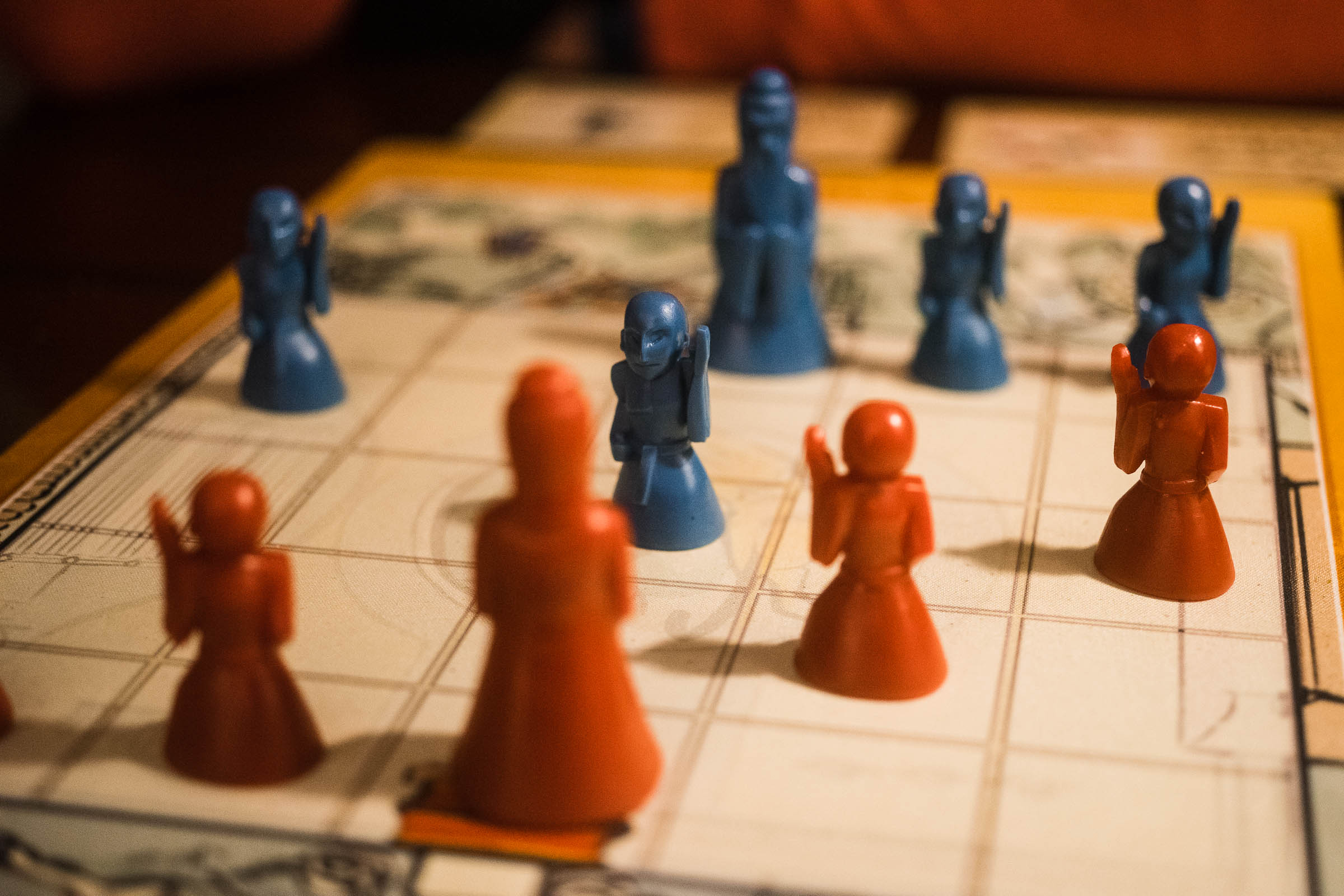 Pieces from Onitama set up on a table.