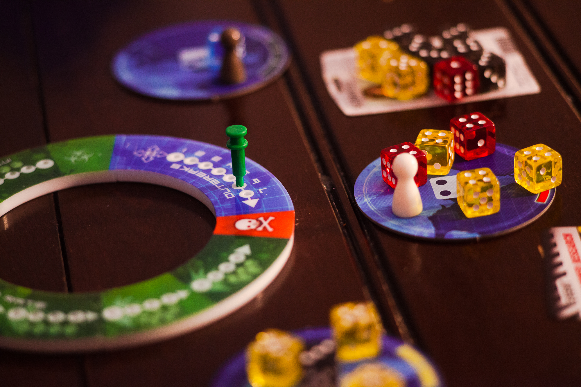 Dice, locations, and a round tracker from the game Pandemic: The Cure.