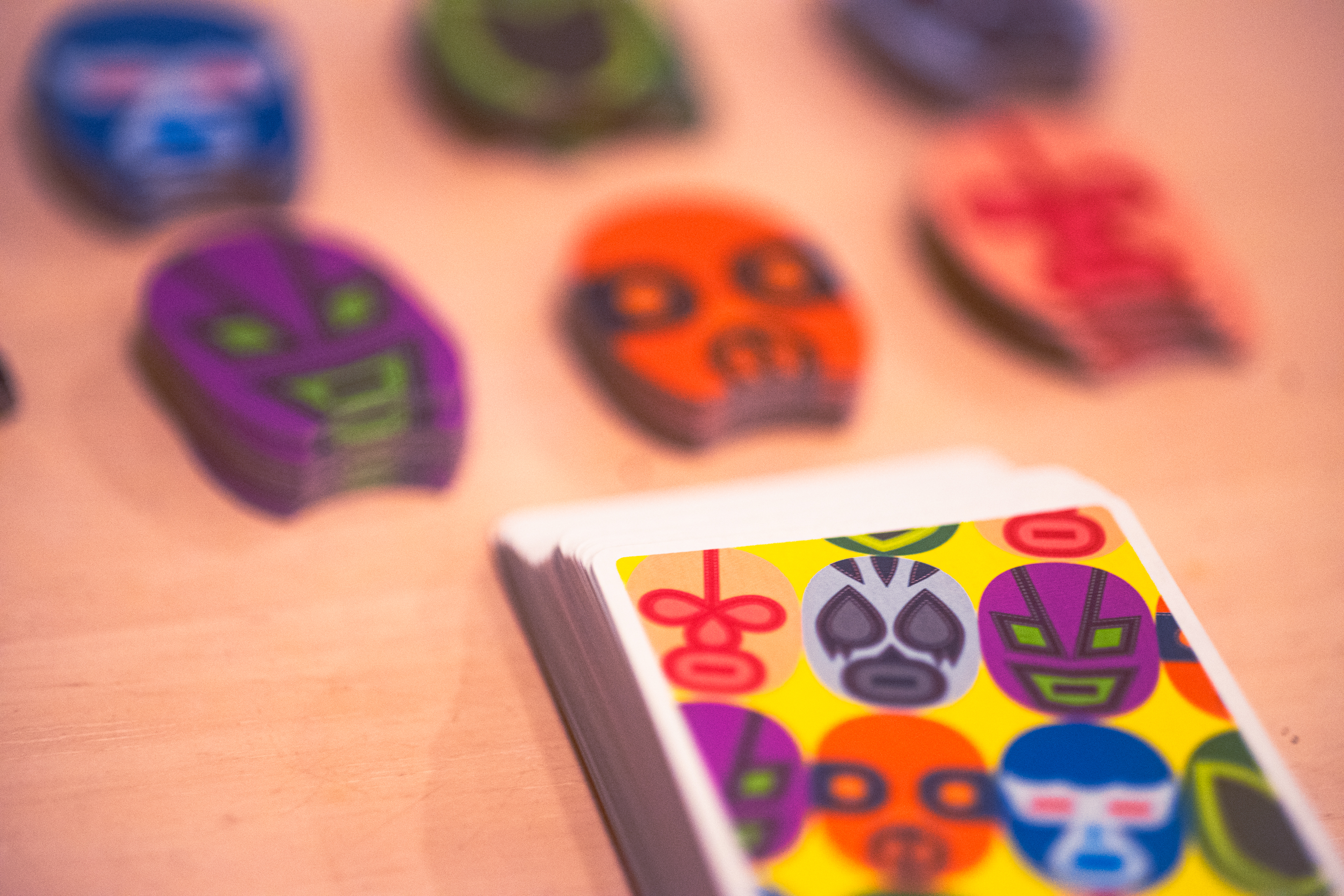 A deck of cards for the game Maskmen, as well as luchador tokens for tracking suit strength.