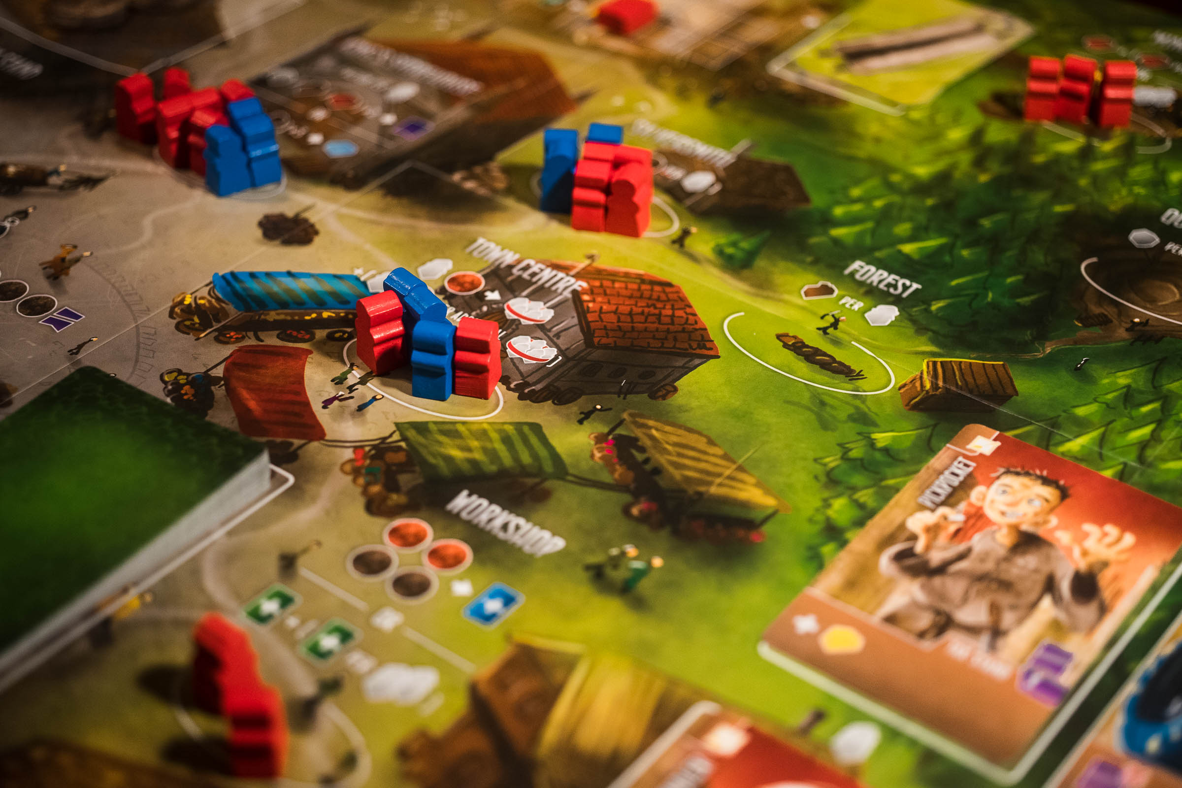 Workers in the game Architects of the West Kingdom on the game board.