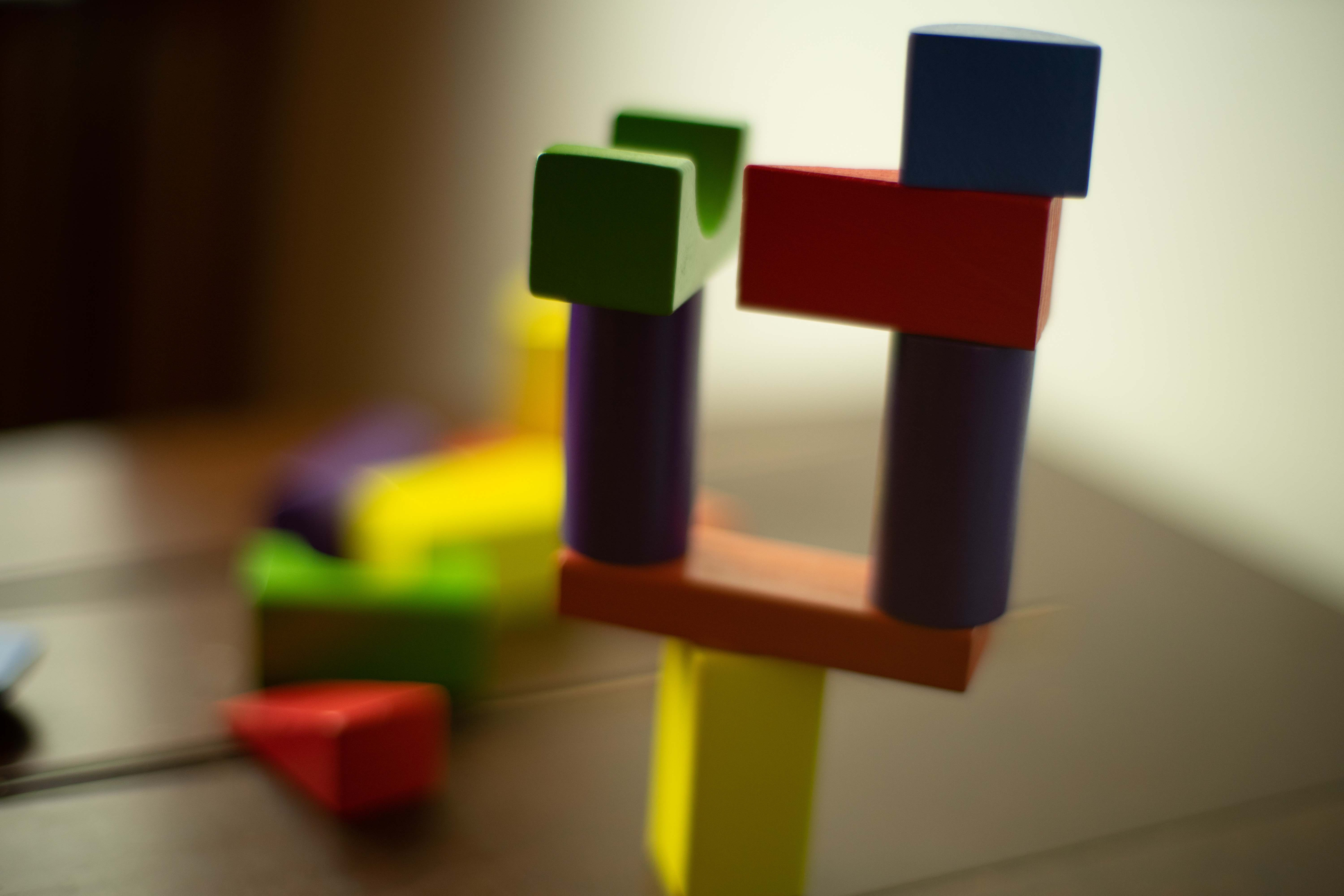 Several pieces from the board game For Science!, which have been stacked precariously.