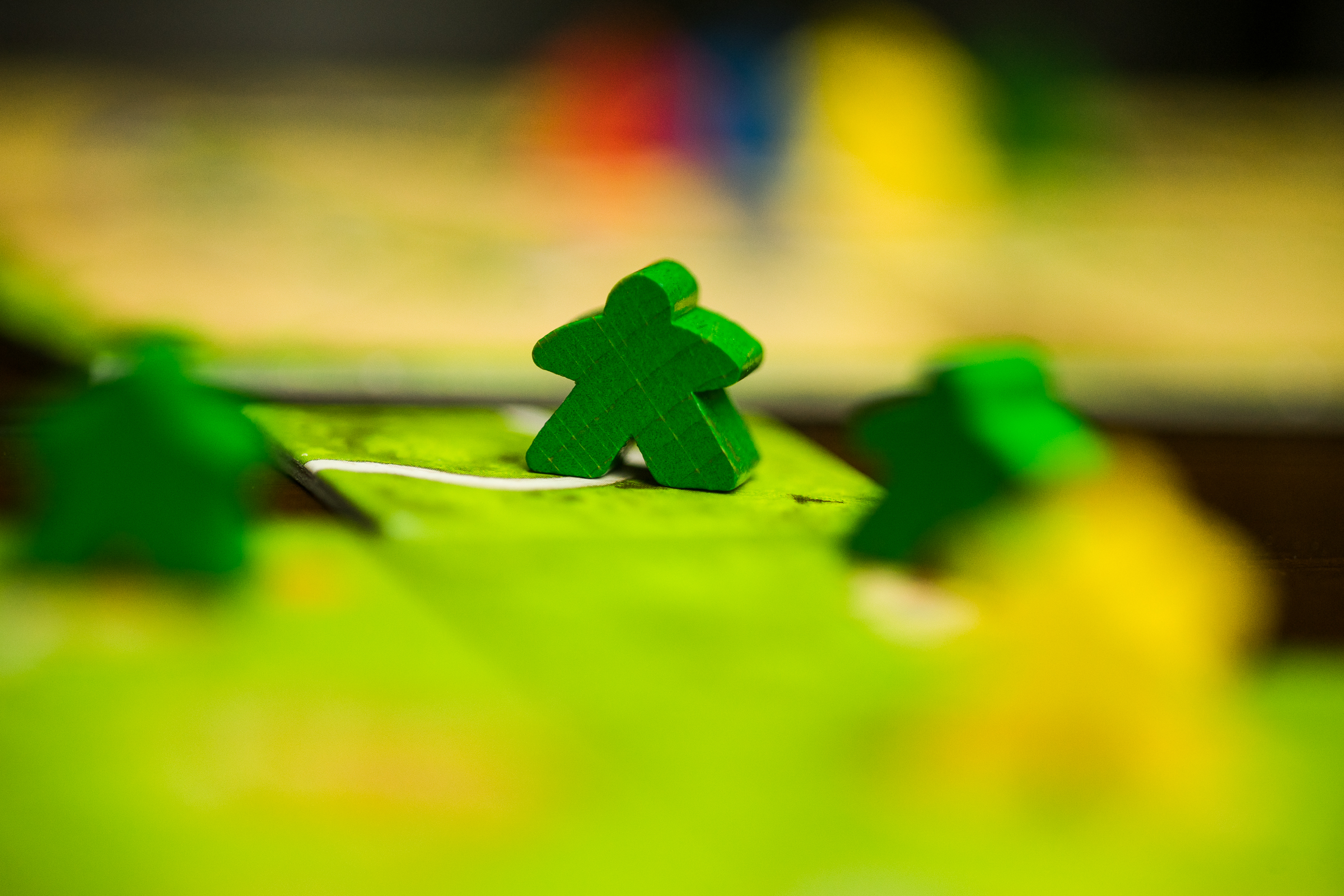 Pieces from the board game Carcassonne, with some in the foreground out of focus.