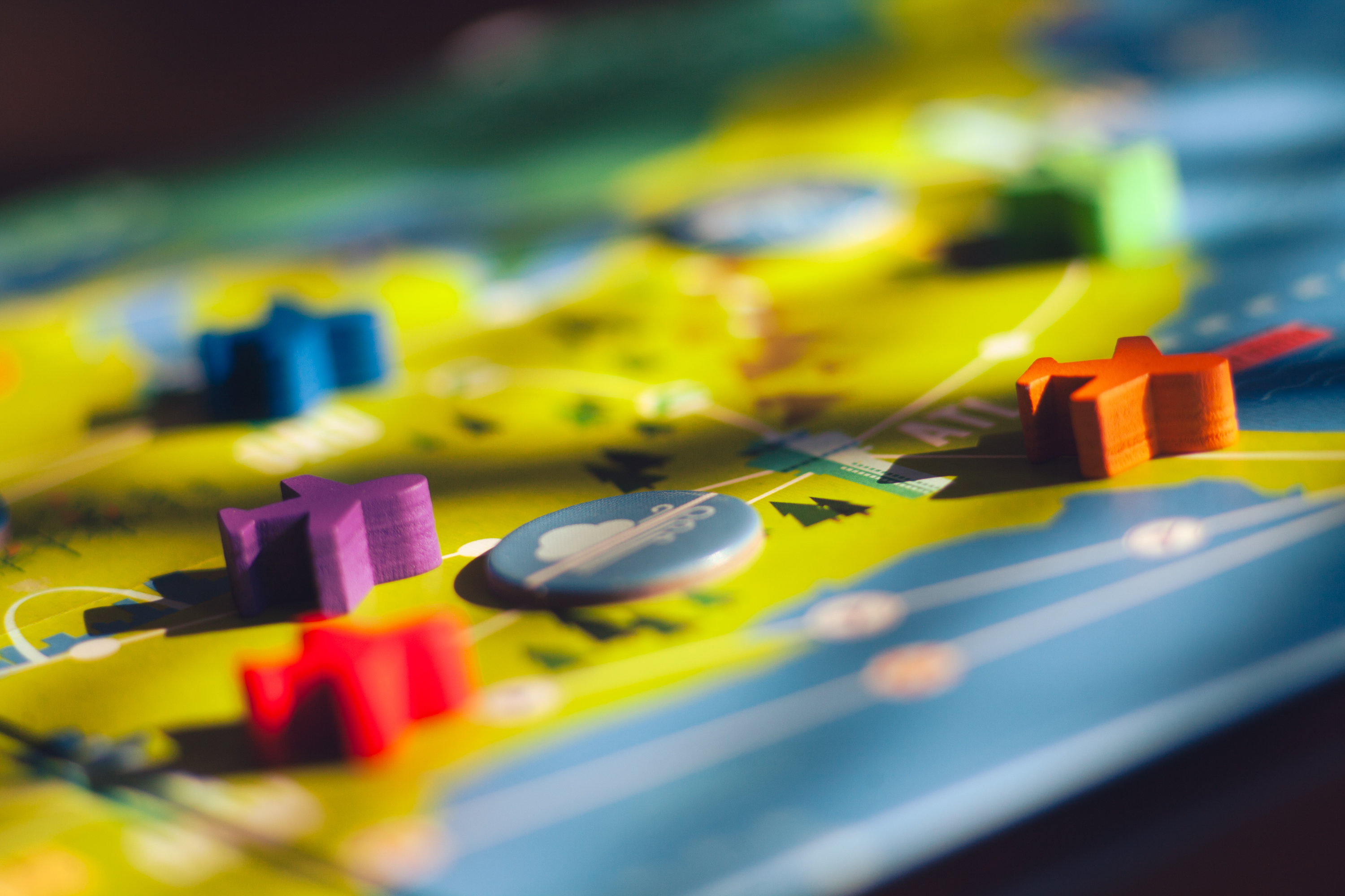 Wooden airplane figures on a board in the game Now Boarding