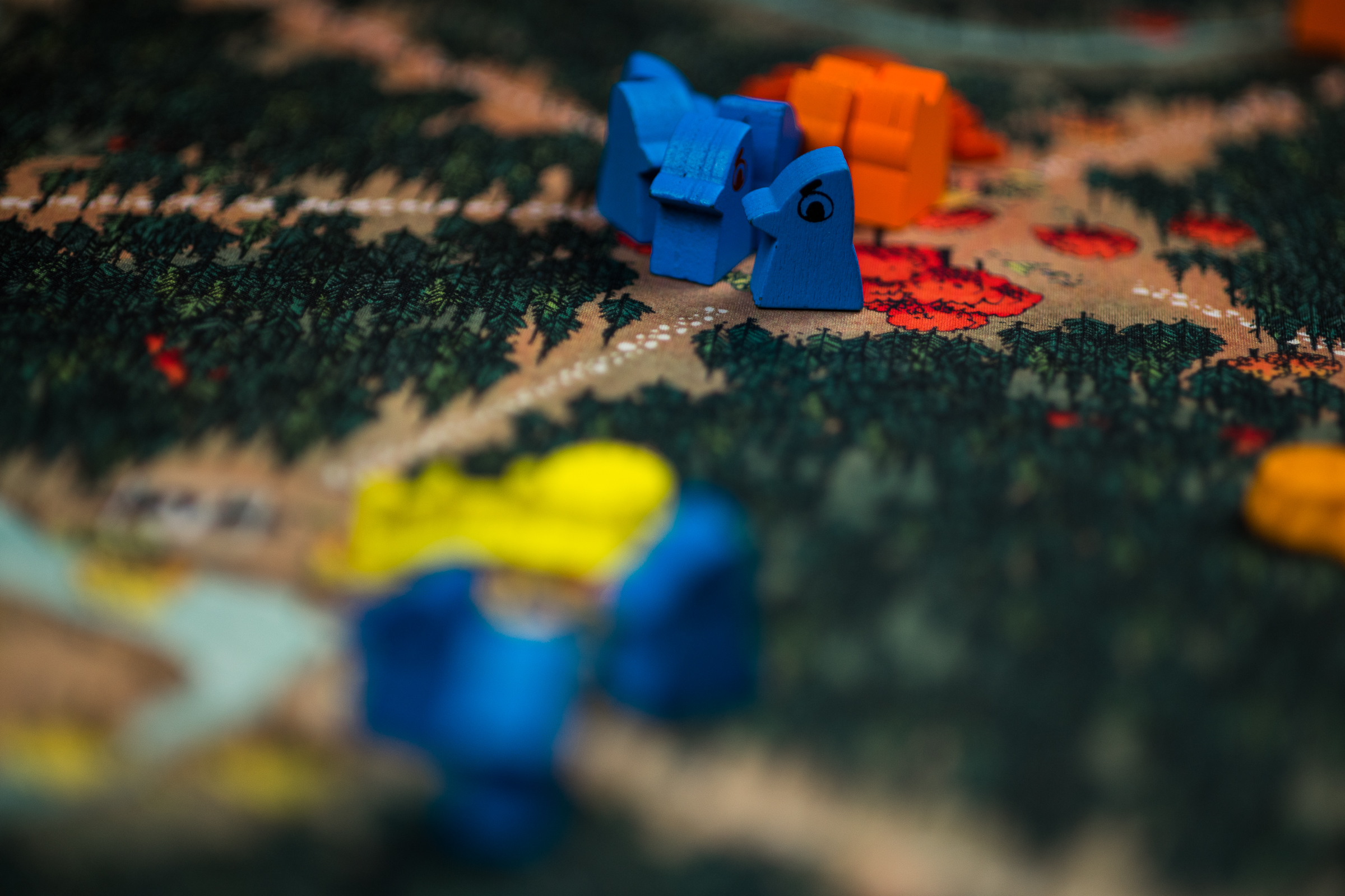 The board game Root. Tokens from the Maquise de Cat and Eyrie Dynasty are visible in a clearing.