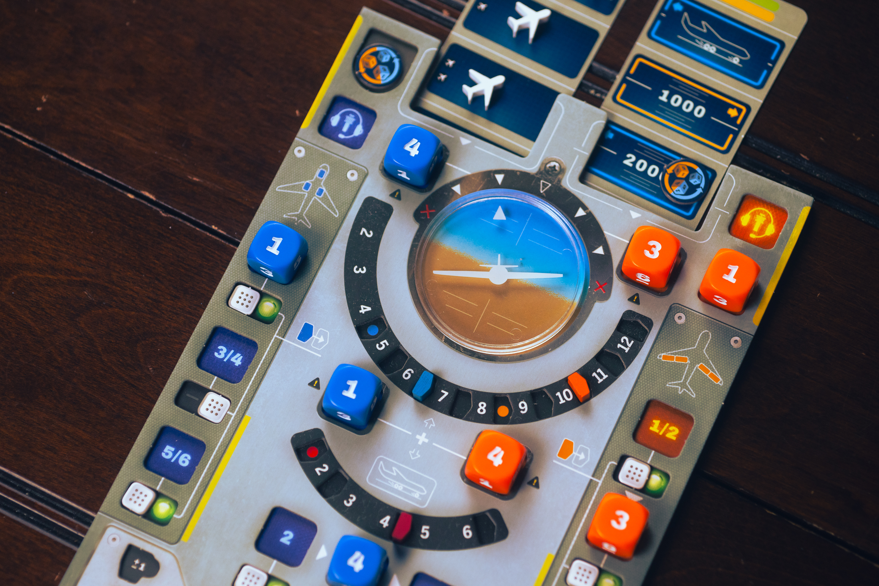The airplane board for the game Sky Team, with dice placed in various locations on the board.