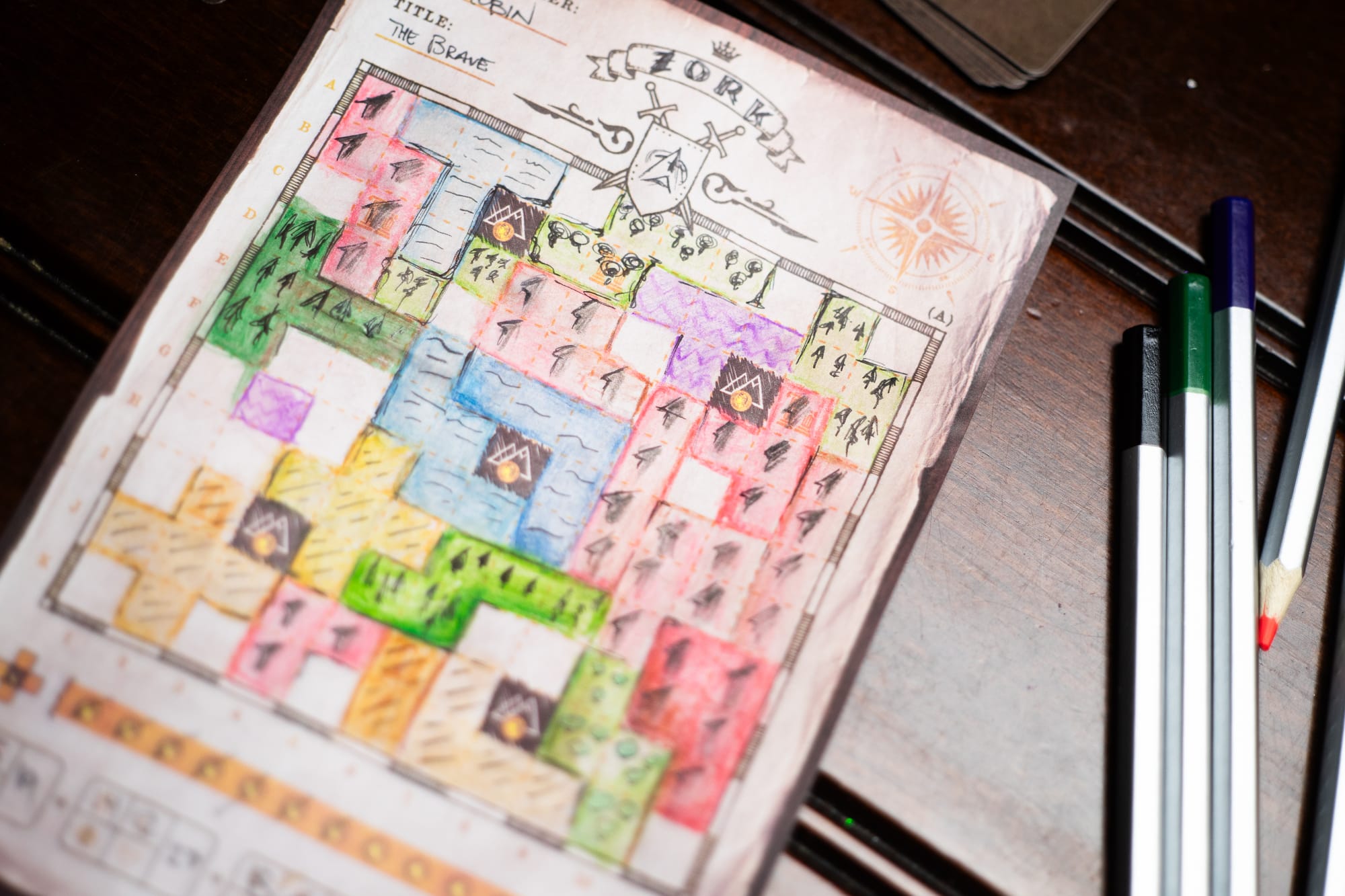 A map from the game Cartographers on a table with colored pencils
