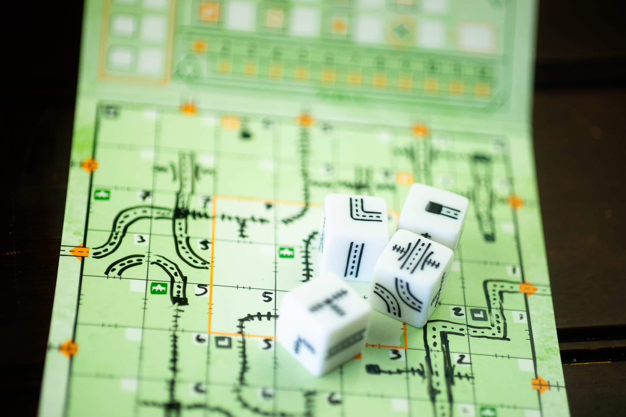 Dice on top of a player board for the game Railroad Ink