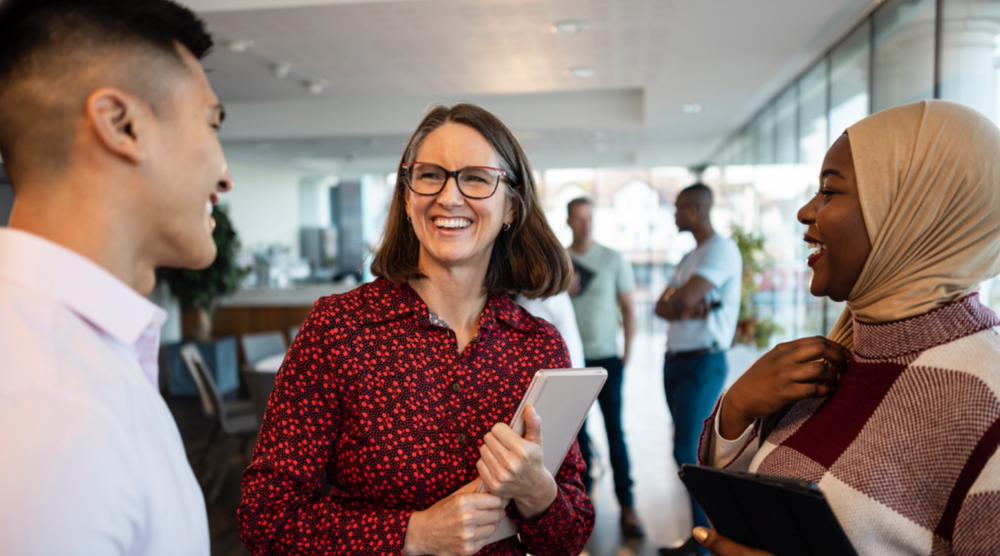Three people conversing in an office