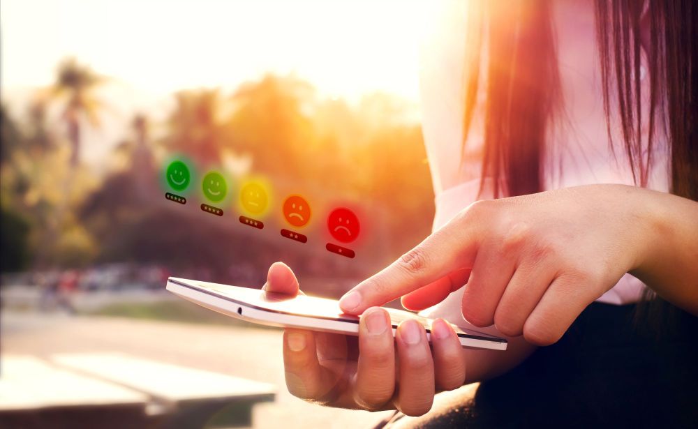 Person with long hair completing an ESG social metrics survey on a cell phone