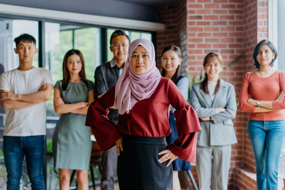 Image of confidence Muslim businesswoman and her colleagues.
