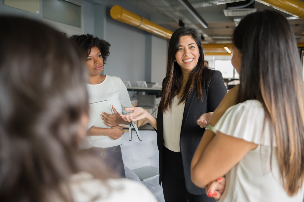 Businesswomen having informal conversation meeting in office