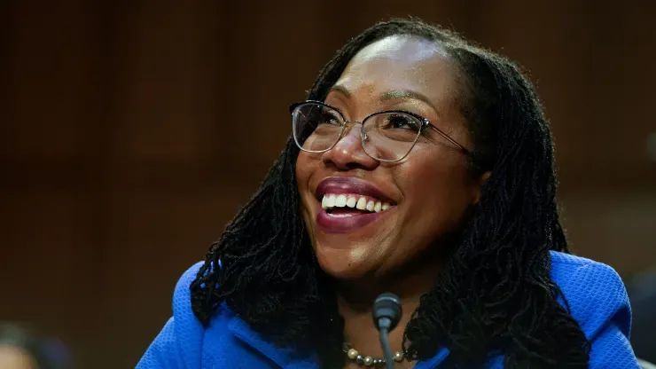 Judge Ketanji Brown Jackson listens to U.S. Senator Cory Booker speak 
