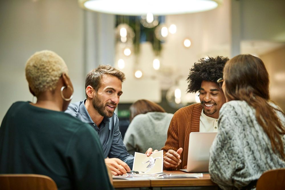 Group of young professional marketers around a table