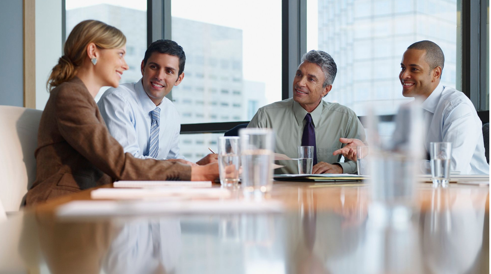 Team of executives sitting at a conference table