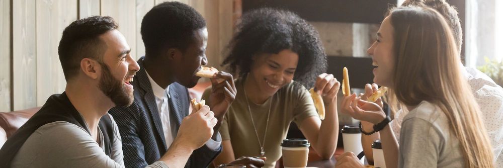 Team of young people eating pizza