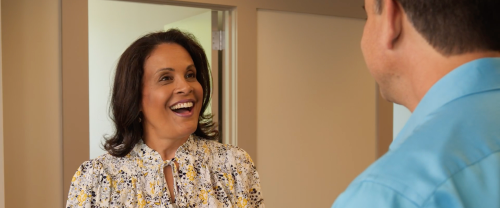 Two people speaking in an office setting
