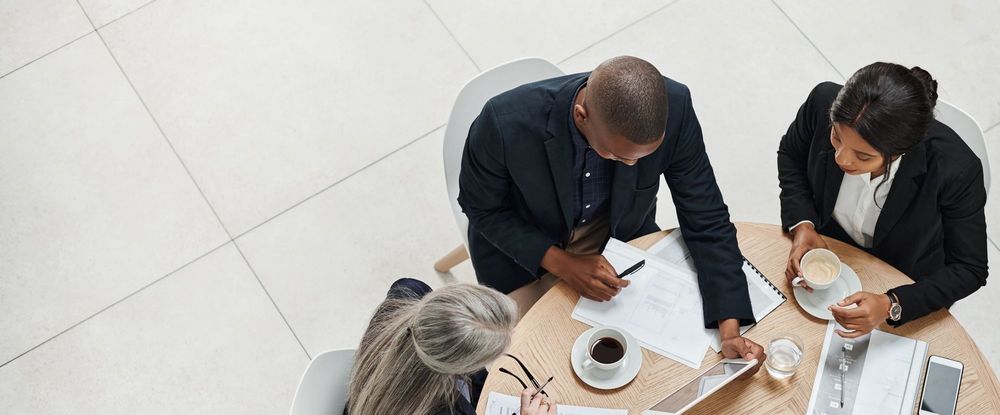 Three people sitting at an office table