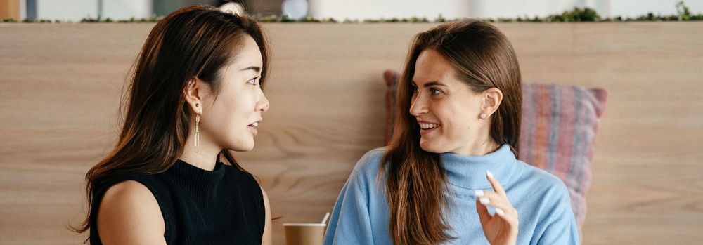 Two women talking in an office setting