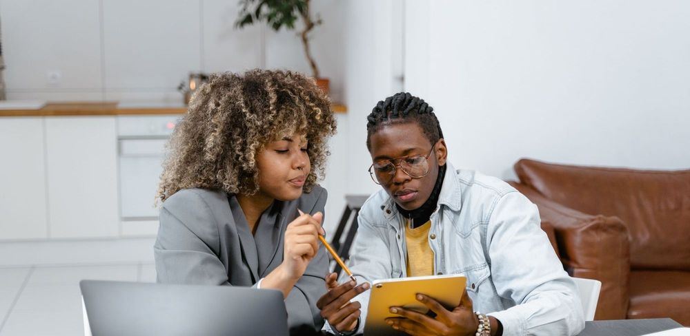 Two people of color collaborating