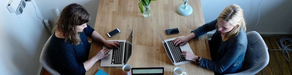 Three women sitting at a conference table