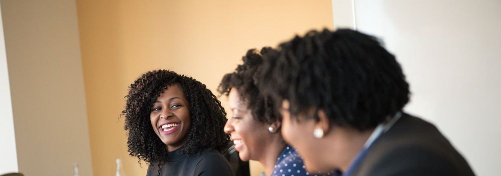 Three Black women sitting at a conference table