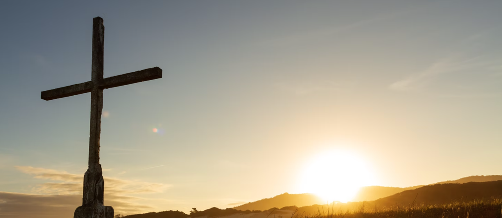 Cross in front of sunset in Florianópolis, SC, Brasil