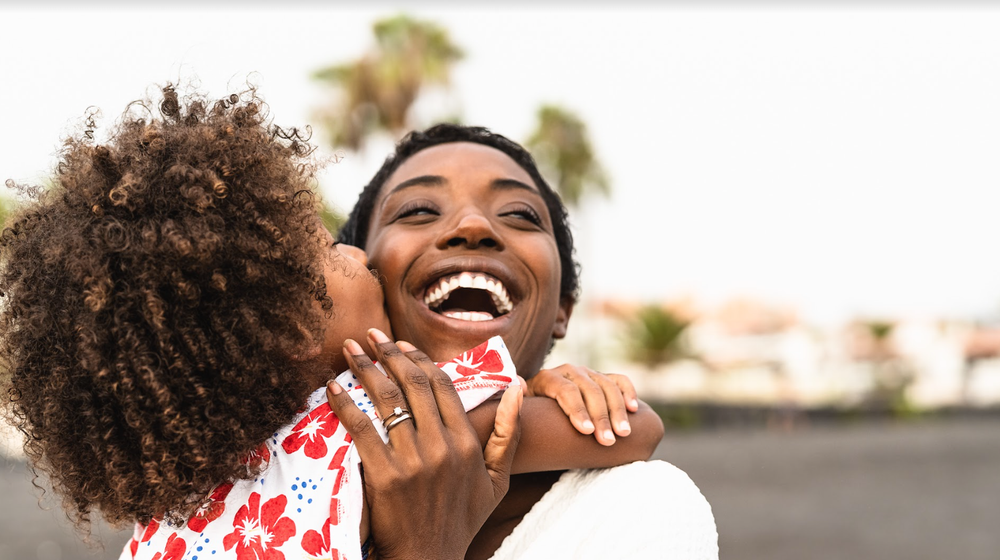 Jamaican mother and son embracing