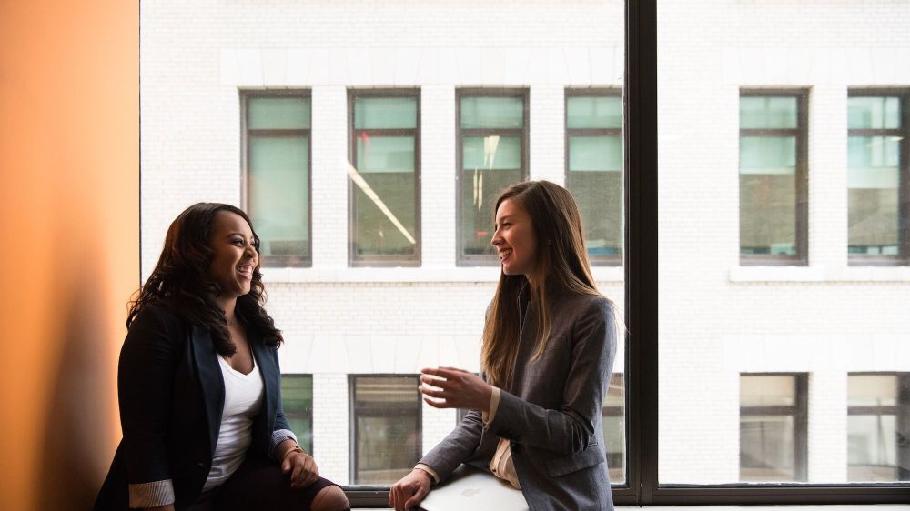 Two women conversing in a window