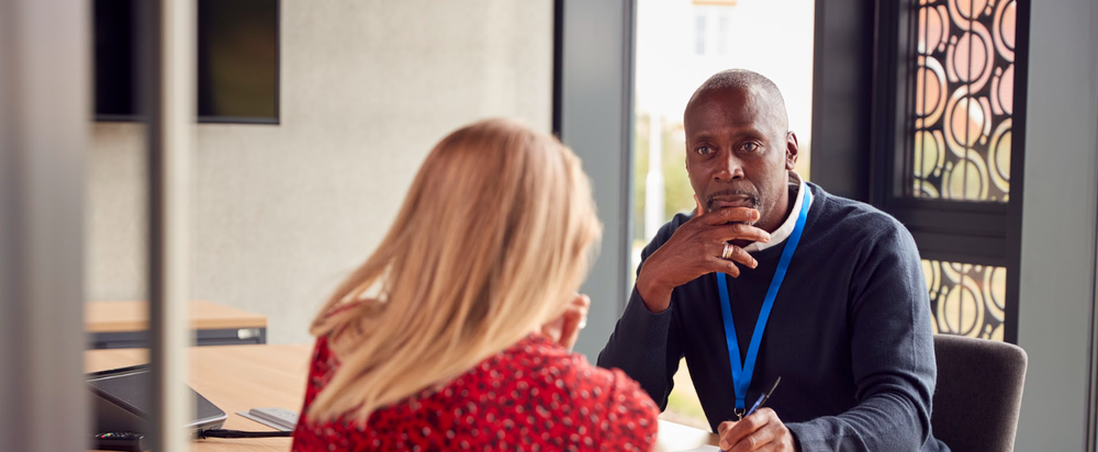 An inclusive listener engages with a colleague in an office