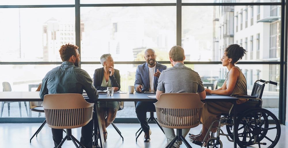 Inclusive leaders collaborate around a conference table